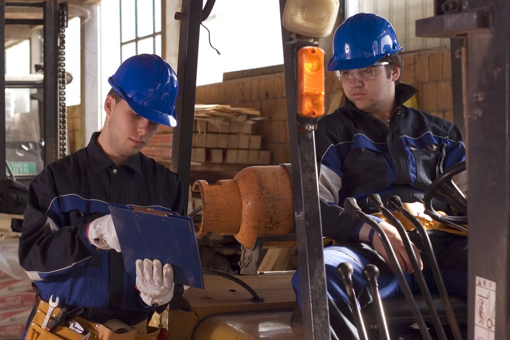 safety consultant talking to a forklift operator about safety and hazards