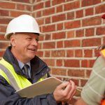 foreman with clipboard checks safety