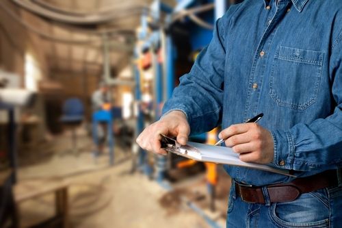 Safety Officer With Checklist During An Inspection