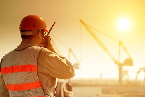 supervisor communicates with staff on hot sunny day at construction site