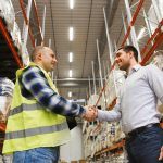 Two co-workers shaking hands