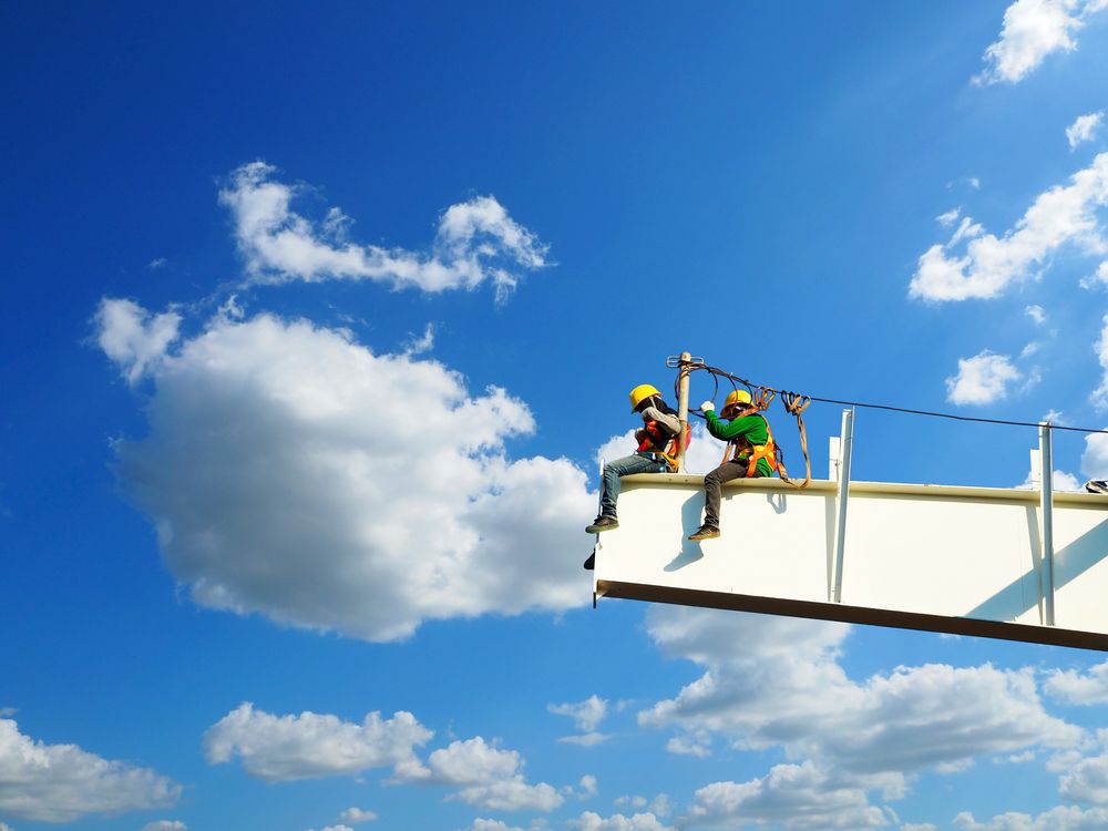 two men working at heights on construction site
