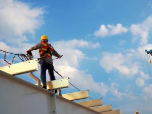 man working at heights on roof