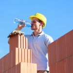Worker fighting dehydration and heat stress on hot day