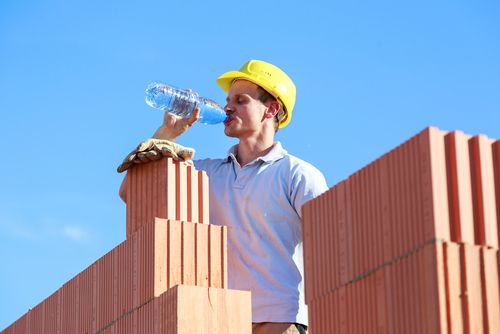 Worker fighting dehydration and heat stress on hot day