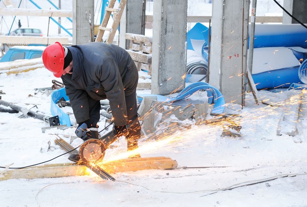 worker operating equipment in winter