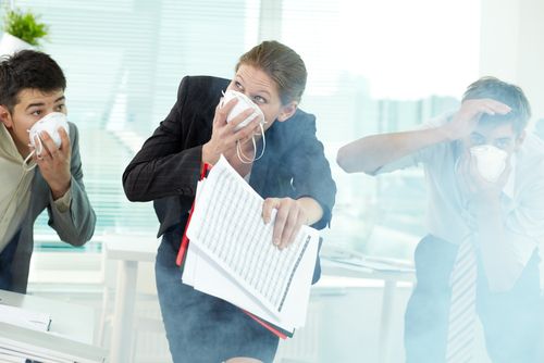 staff cover mouths while escaping fire