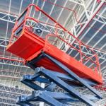 scissor lift operating near top of building