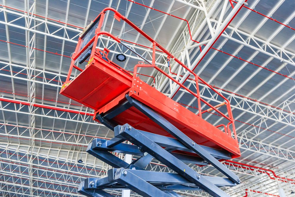 scissor lift operating near top of building