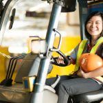 Woman smiling while attending forklift safety training