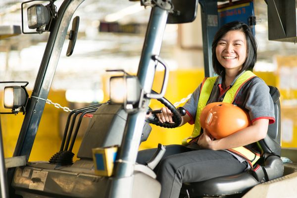 Woman smiling while attending forklift safety training