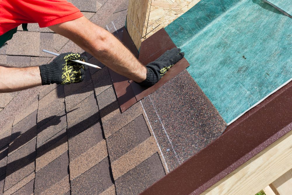 a roofer working on a house to install new roofing