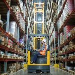 worker safely uses telescopic forklift in ontario warehouse
