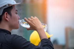 worker drinks water stays hydrated at job site