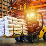 Worker uses forklift to safely transport material across ontario warehouse