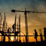 workers at construction site at sunrise