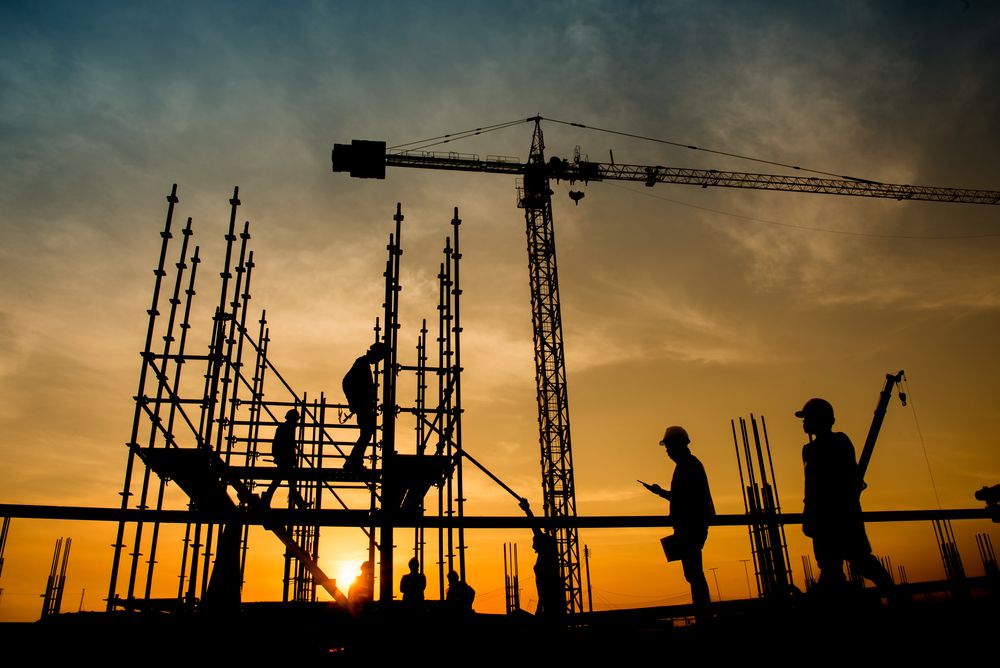 workers at construction site at sunrise