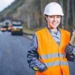 Female worker on a road paving site