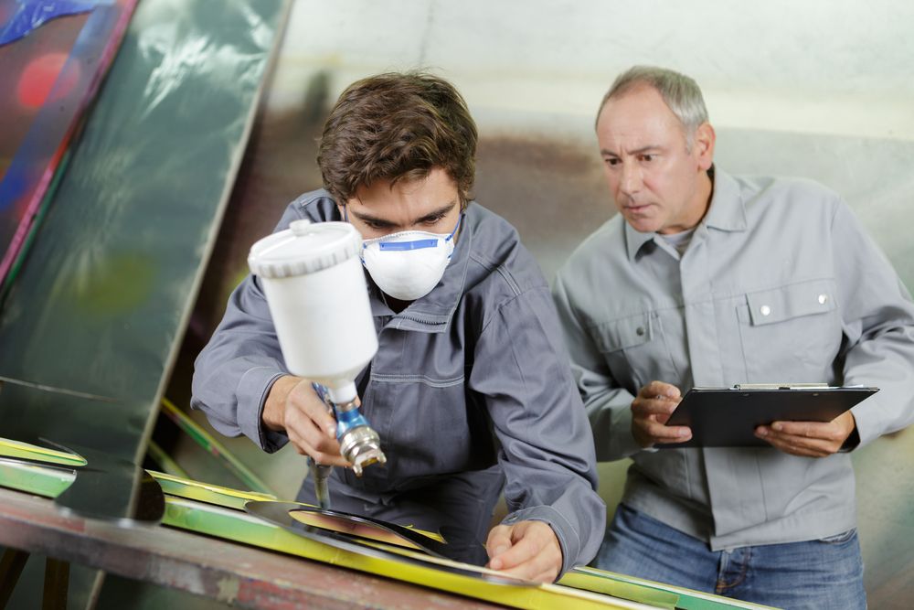 man supervises employee with checklist