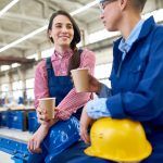 Two young workers enjoying a coffee break