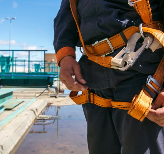 A construction worker wearing a safety harness