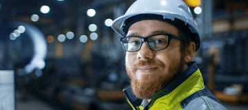 A member of a joint health and safety committee smiles at the camera