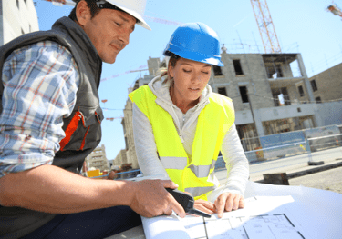 Two supervisors go over construction plans